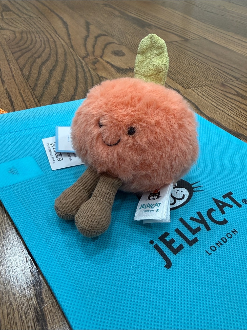 Jellycat Amuseables Peach Plush with Brown Legs and Green Leaf
